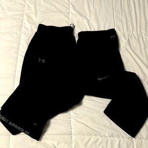 2 pair Men’s XXL athletic pant, one under armour one Nike.  Mesh lining